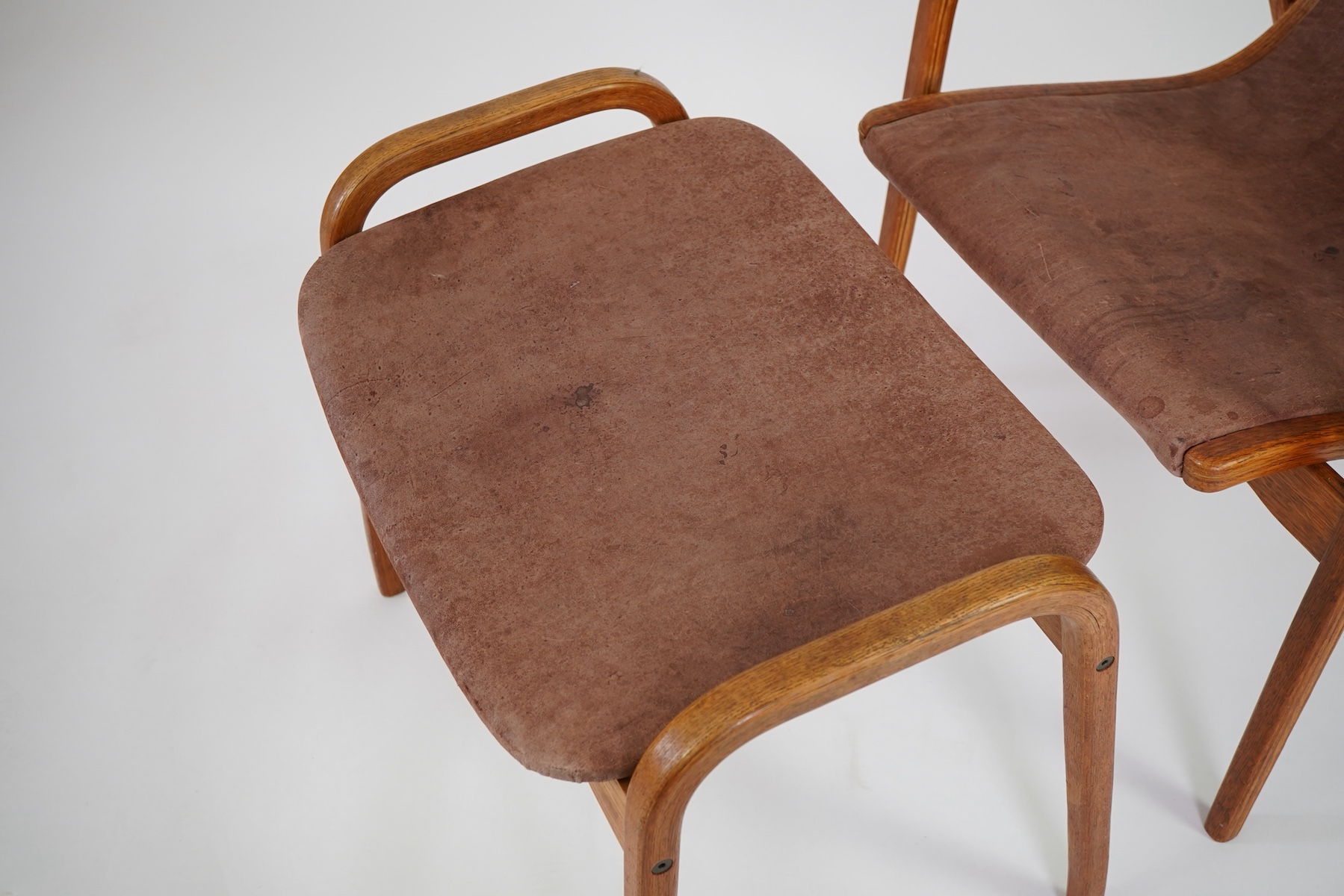 Yngve Ekström (Swedish, 1913-1998) for Swedese Möbler AB: A 'Lamino' oak lounge chair and ottoman